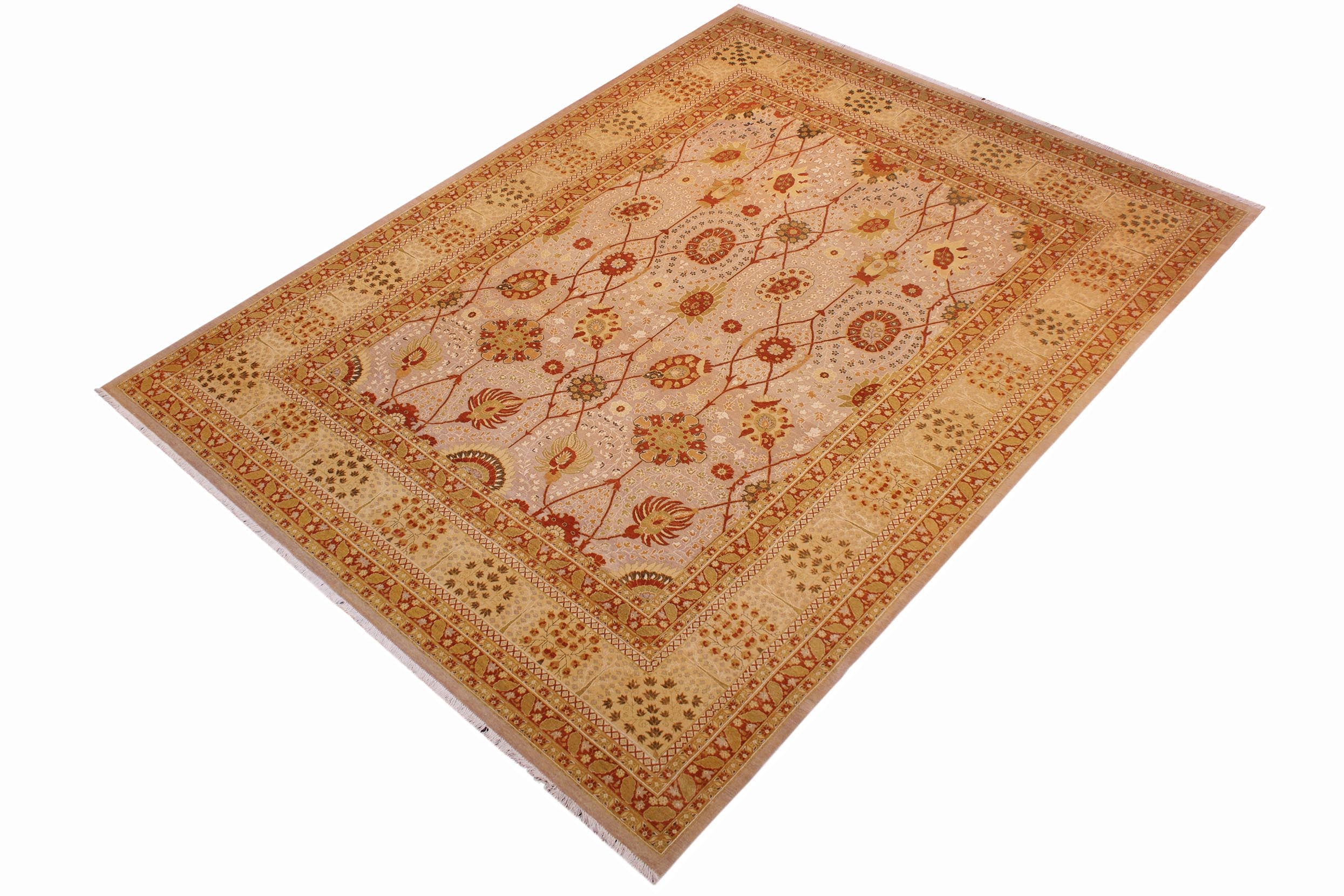 A rectangular area rug with an intricate traditional floral pattern in shades of beige, orange, and brown, shown from an elevated angle on a white background.
